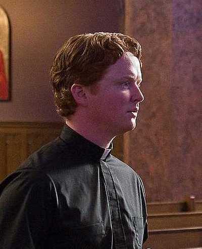 4Christopher Carley as Father Janovich